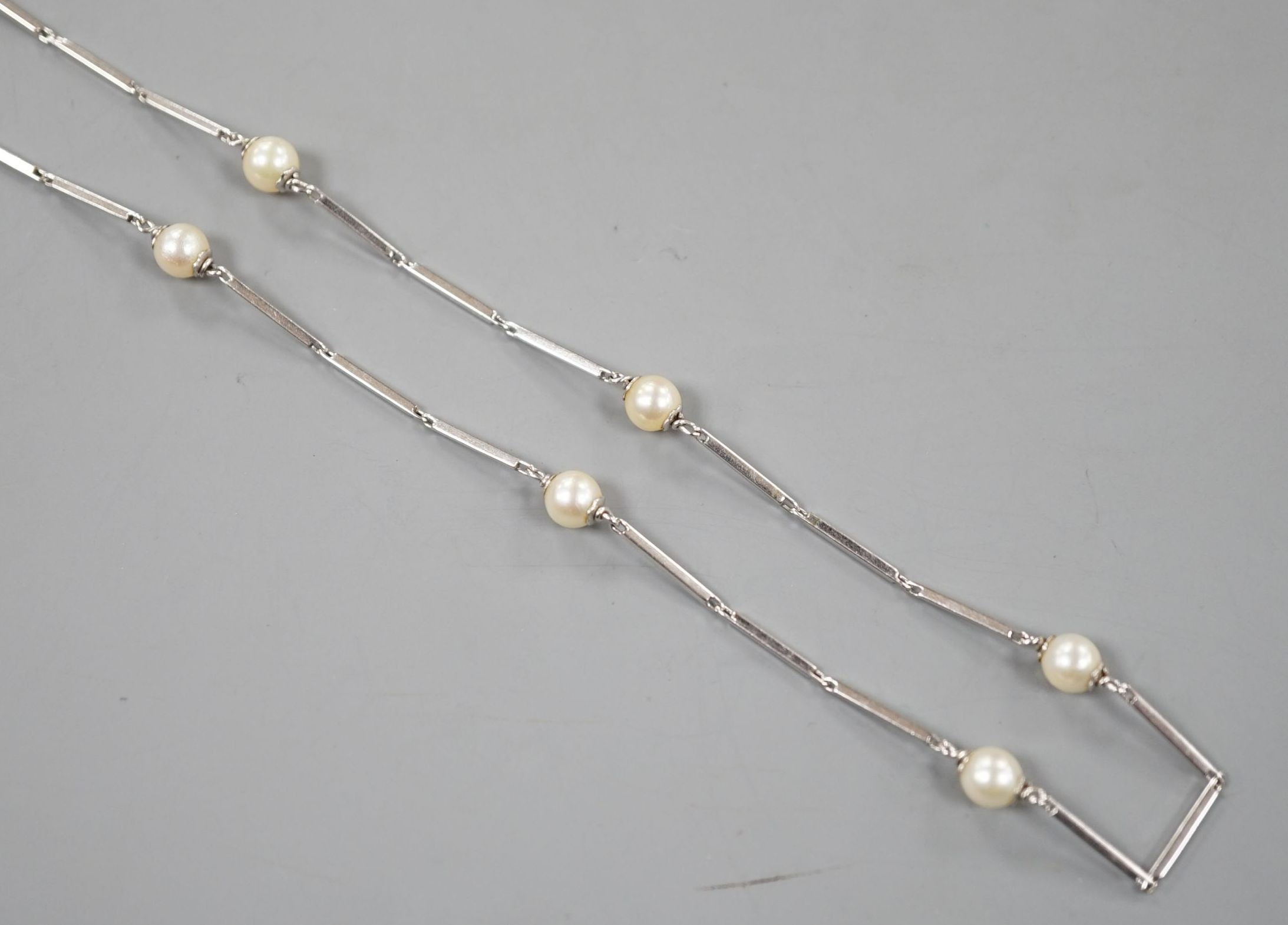 A modern Italian 750 white metal baton link and cultured pearl set necklace, 58cm, gross weight 12.7 grams.